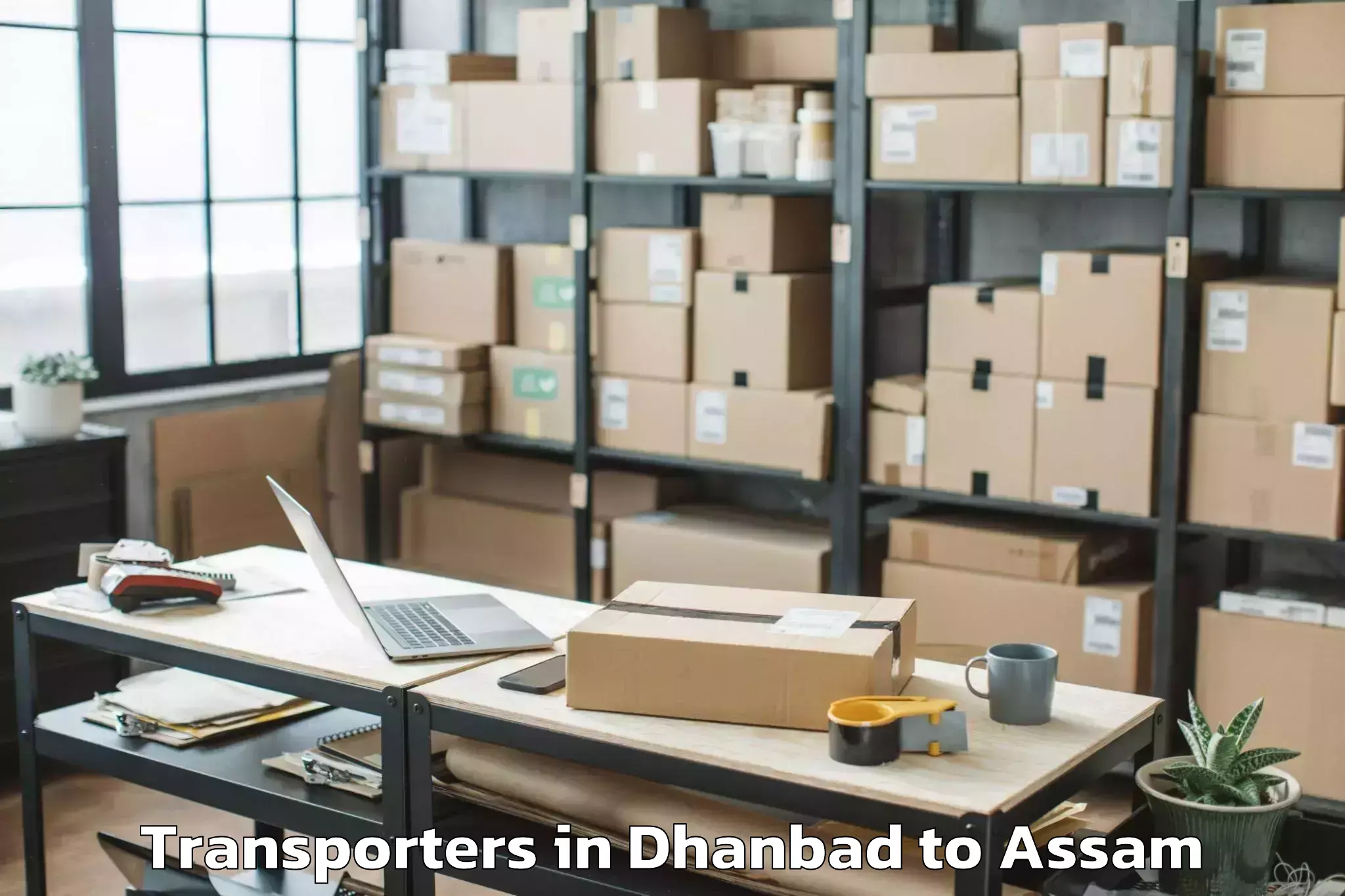 Book Dhanbad to Chariduar Transporters Online